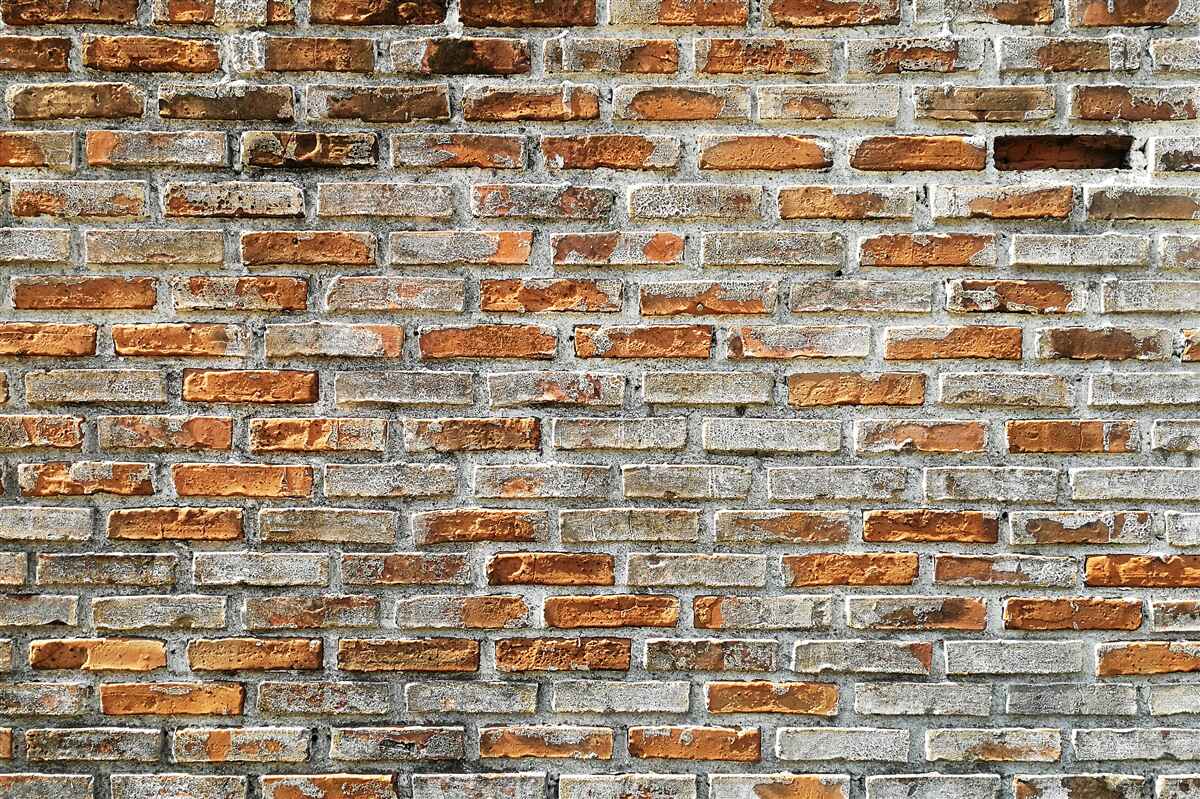 Fotobehang Bakstenen muur in verschillende tinten