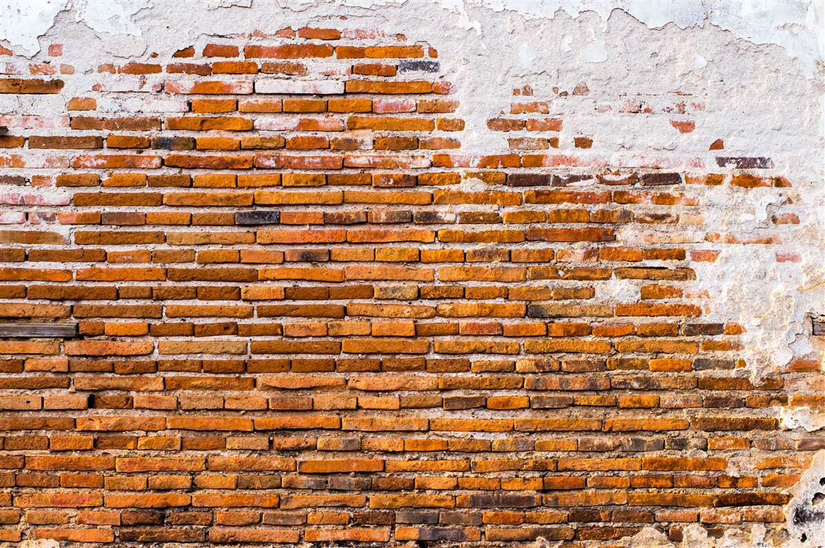 Fotobehang oude bakstenen muur die zijn uiterlijk heeft verloren