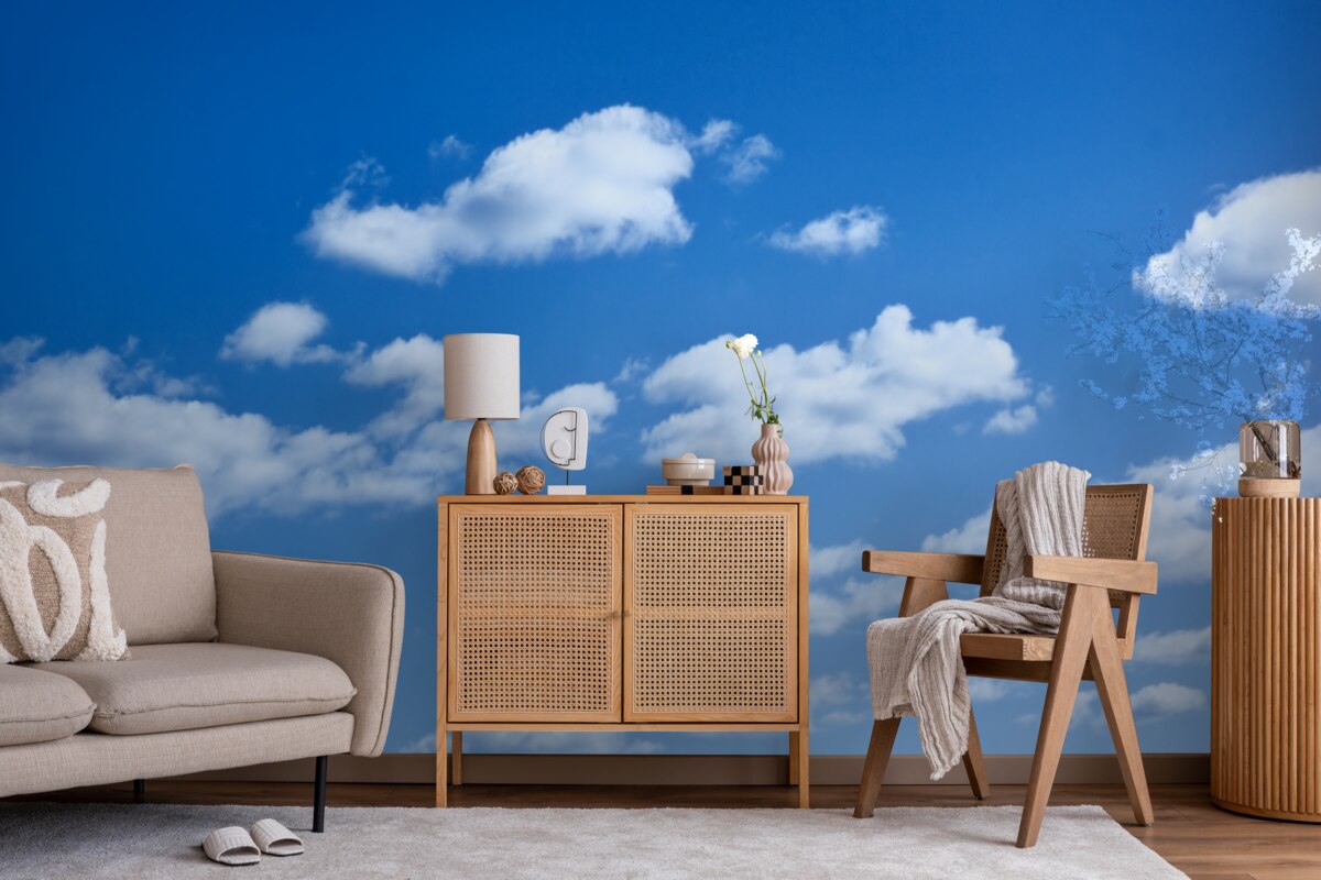 Fotobehang witte wolken drijvend in een blauwe lucht