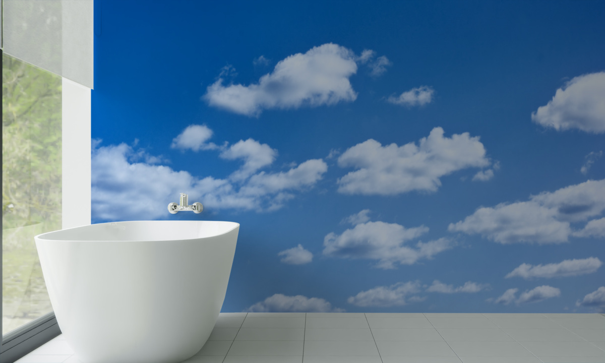 Fotobehang witte wolken drijvend in een blauwe lucht