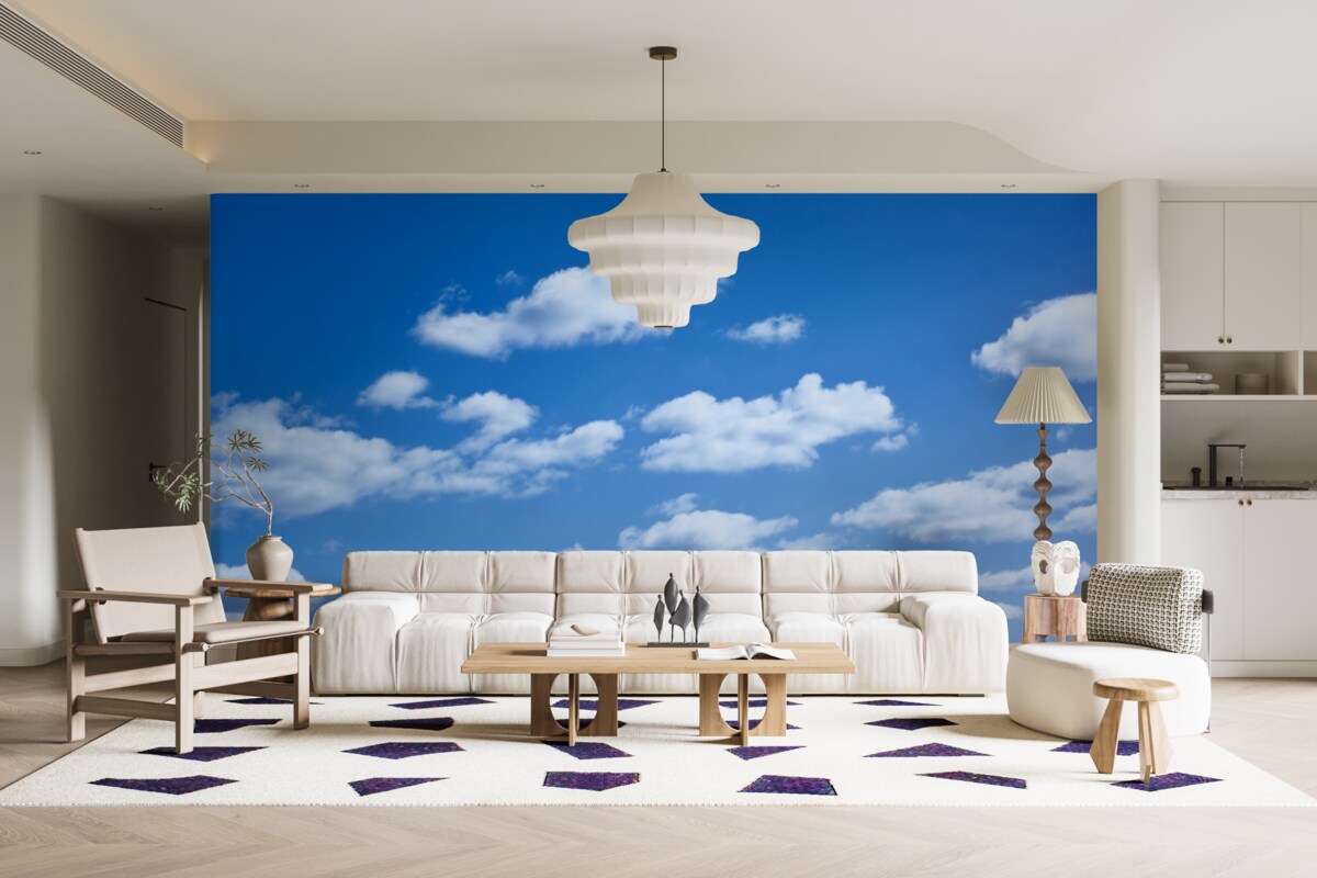 Fotobehang witte wolken drijvend in een blauwe lucht