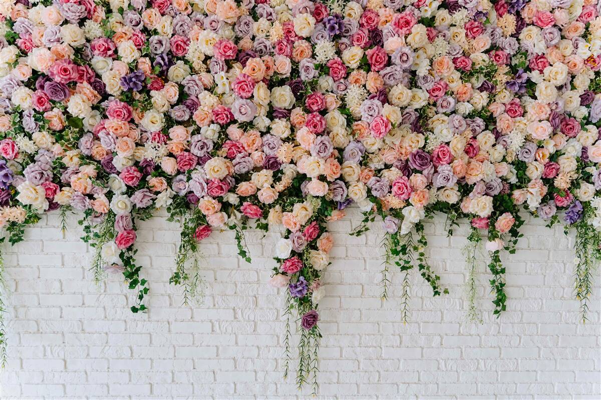 Fotobehang Bakstenen muur versierd met rozenstruikbloemen